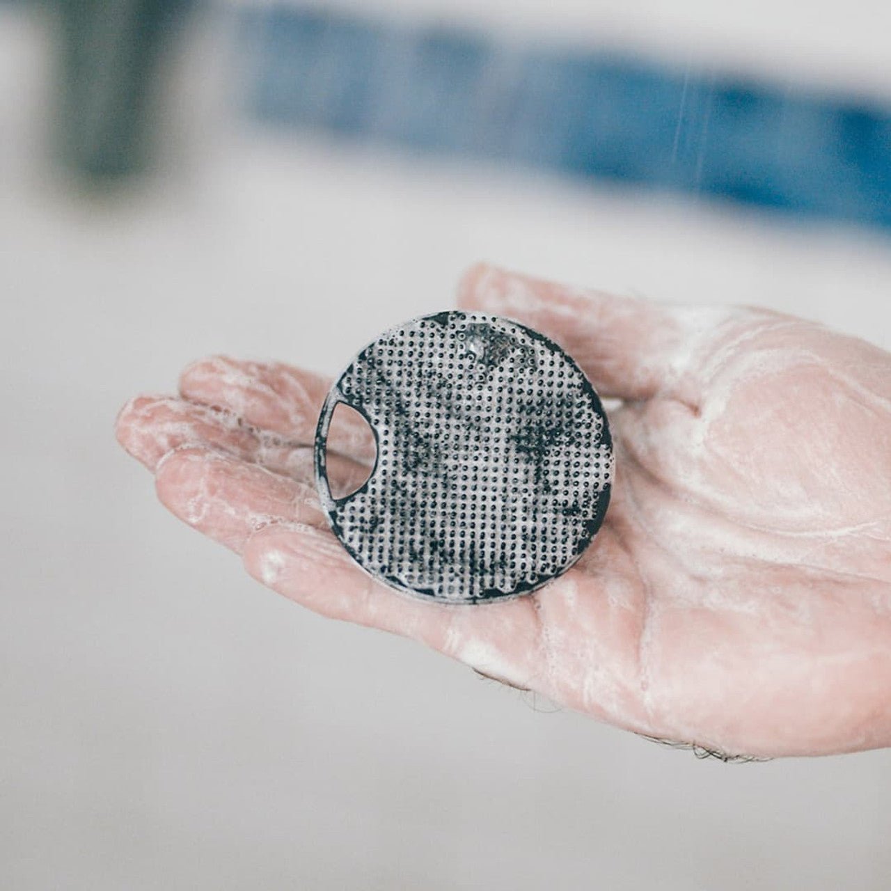 Lumin Face Scrubber and Hook Set in hand in use